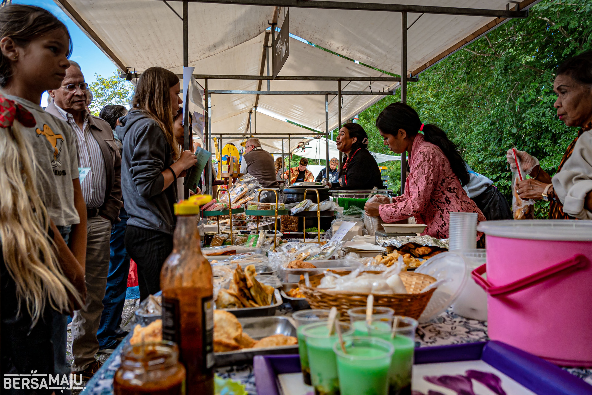 Serving visitors at a busy market